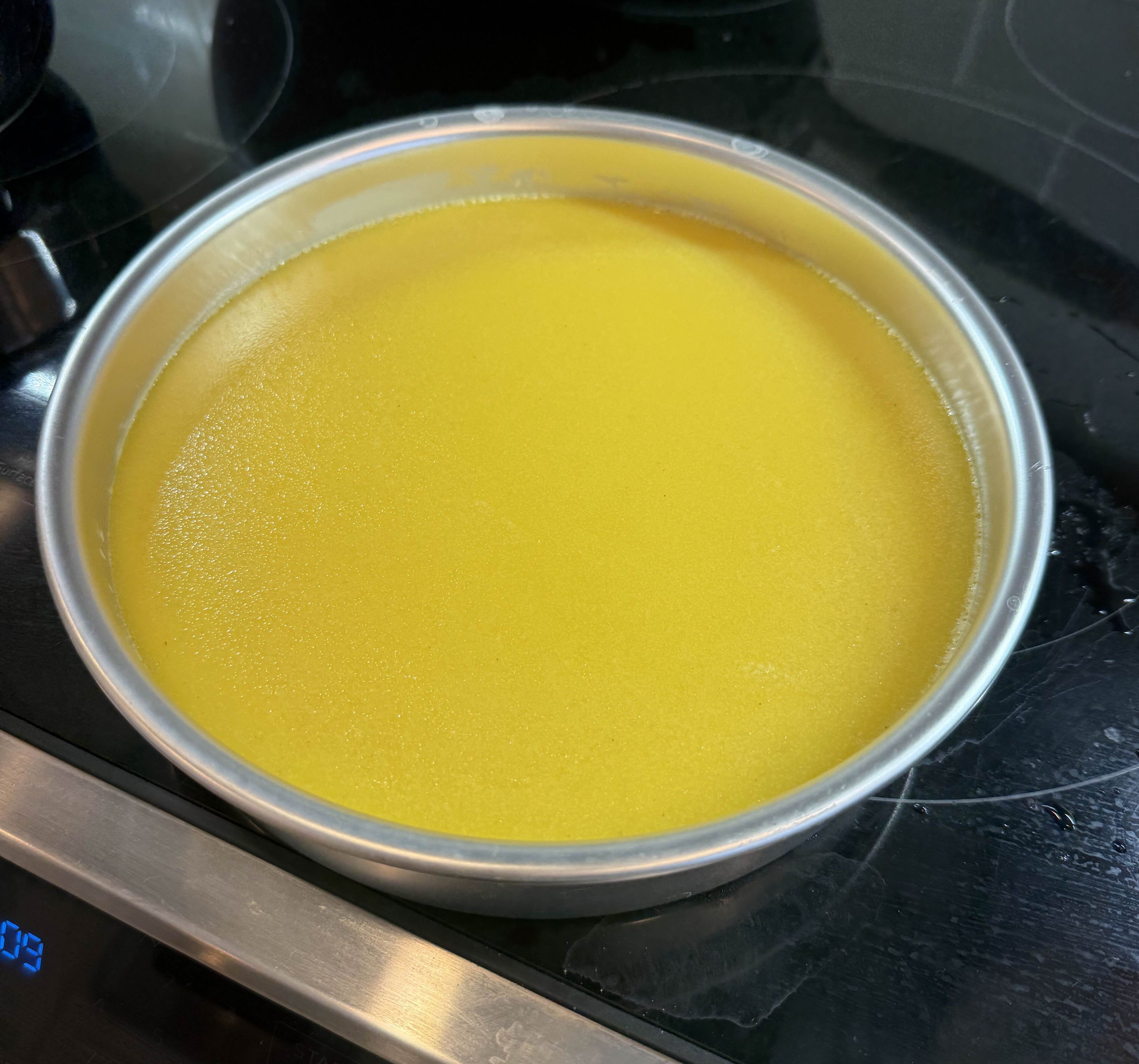 Custard in a round aluminum cake pan
